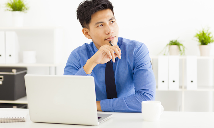 Young asian businessman planning and thinking
