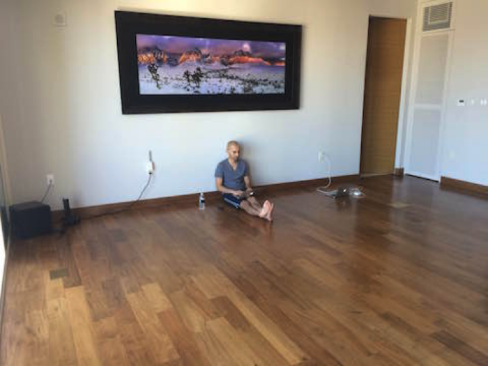 Neil Patel sitting on his living room floor.